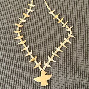 Fossilized ivory Zuni carved bird fetishes and large bird pendant.